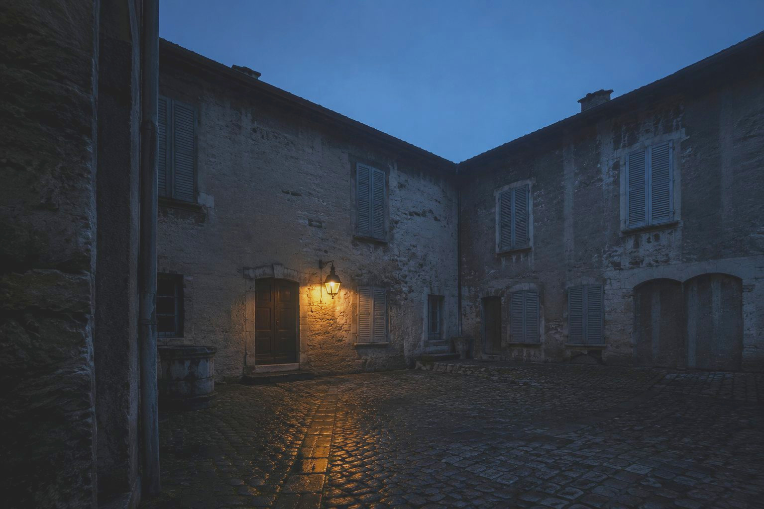A Lyon courtyard lit at nightfall